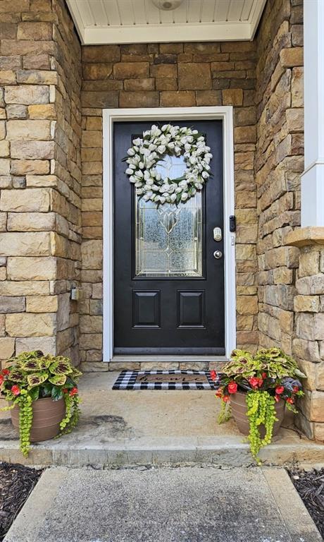 property entrance with stone siding