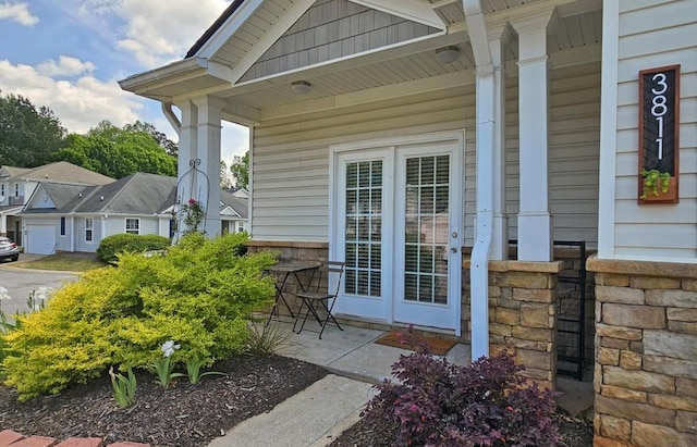 doorway to property featuring stone siding and covered porch