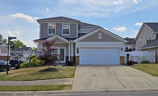 view of front facade with driveway, a front yard, and stone siding