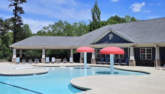 community pool featuring a patio and fence