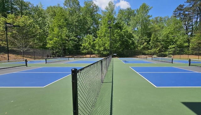 view of tennis court with fence and community basketball court