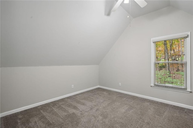 bonus room featuring a ceiling fan, carpet, lofted ceiling, and baseboards