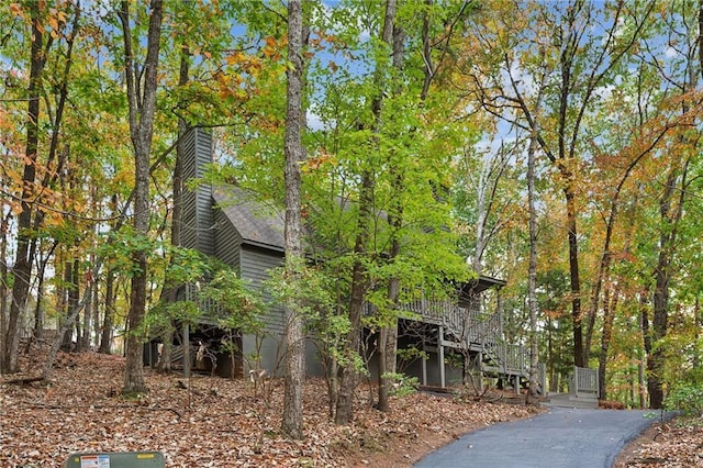 view of home's exterior with a deck and a chimney