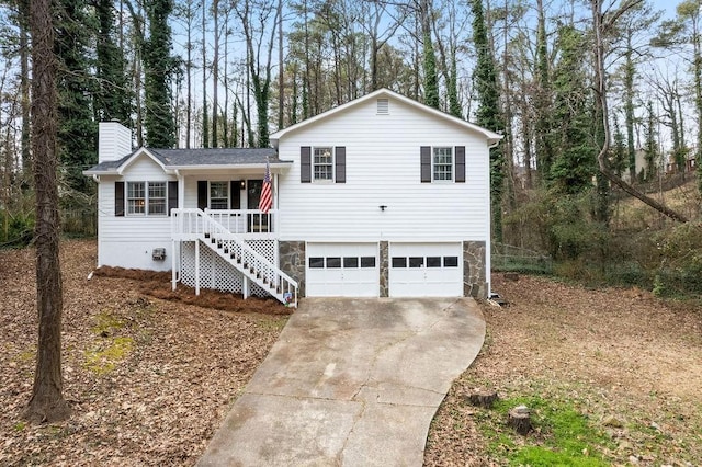 tri-level home with a garage and covered porch