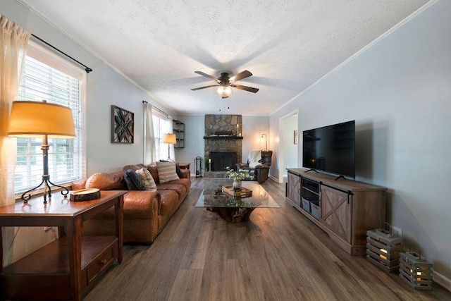 living room with ceiling fan, crown molding, a textured ceiling, and dark hardwood / wood-style flooring