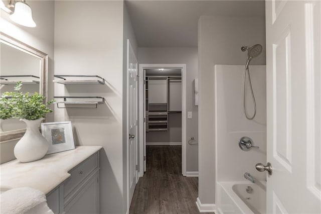 4408 Brandon Ct NE, Marietta, GA 30066 - full bathroom featuring  shower combination, vanity, wood finished floors, baseboards, and a spacious closet