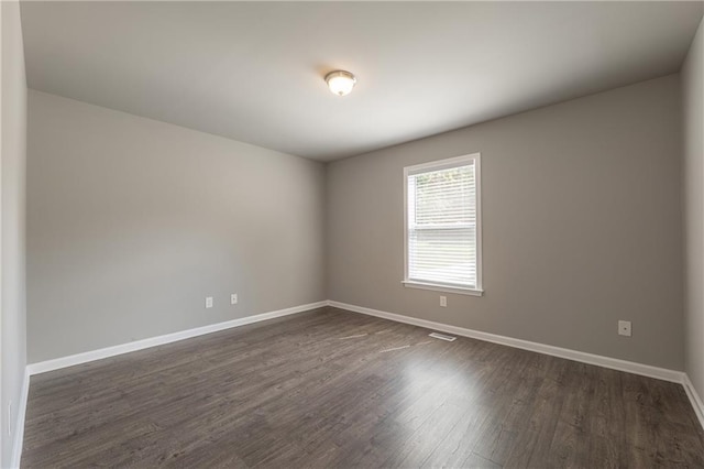 4408 Brandon Ct NE, Marietta, GA 30066 - empty room featuring dark wood-type flooring and baseboards