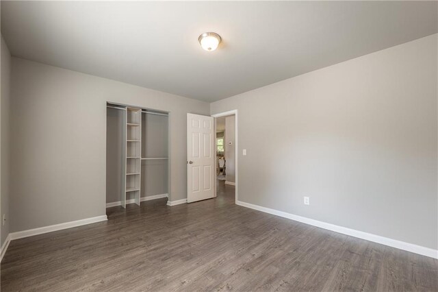 4408 Brandon Ct NE, Marietta, GA 30066 - unfurnished bedroom featuring a closet, baseboards, and wood finished floors