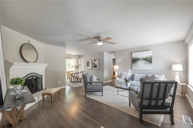 4408 Brandon Ct NE, Marietta, GA 30066 - living room featuring ceiling fan, baseboards, wood finished floors, and a fireplace with raised hearth