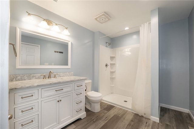 4408 Brandon Ct NE, Marietta, GA 30066 - bathroom featuring wood finished floors, toilet, vanity, and a shower with shower curtain