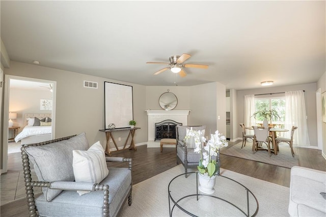 4408 Brandon Ct NE, Marietta, GA 30066 - living area featuring a ceiling fan, wood finished floors, a brick fireplace, and baseboards