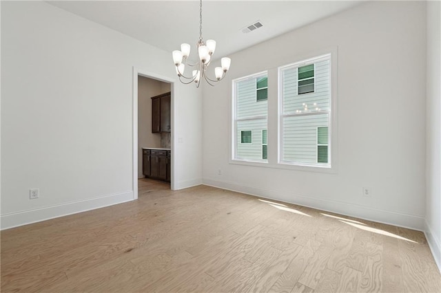 784 Keystone Dr, Woodstock, GA 30188 - spare room featuring a chandelier, baseboards, and light wood-style flooring