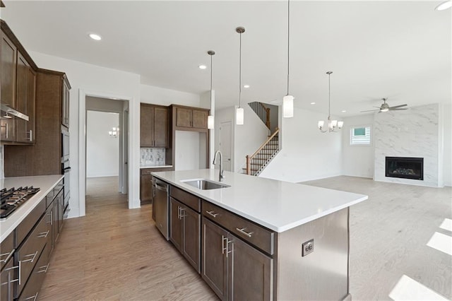 784 Keystone Dr, Woodstock, GA 30188 - kitchen featuring a sink, stainless steel appliances, a ceiling fan, light wood finished floors, and light countertops