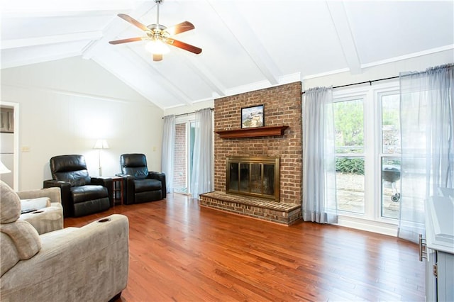 living room featuring a brick fireplace, wood-type flooring, vaulted ceiling with beams, and ceiling fan