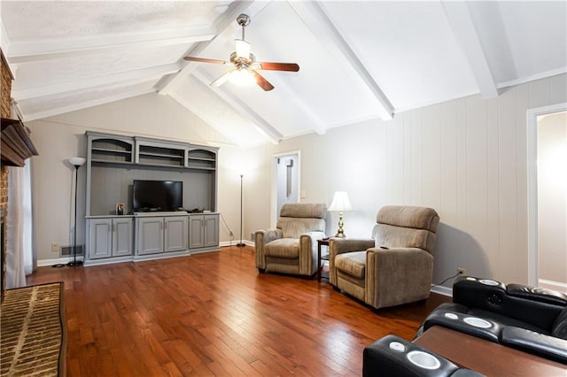 living room featuring ceiling fan, dark hardwood / wood-style flooring, lofted ceiling with beams, and a brick fireplace