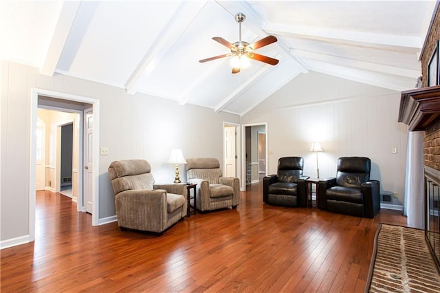 living room with dark hardwood / wood-style flooring, a brick fireplace, lofted ceiling with beams, and ceiling fan