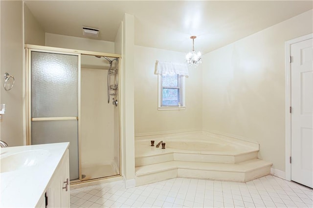 bathroom with a chandelier, tile patterned floors, vanity, and separate shower and tub