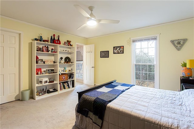 bedroom with crown molding, ceiling fan, and carpet