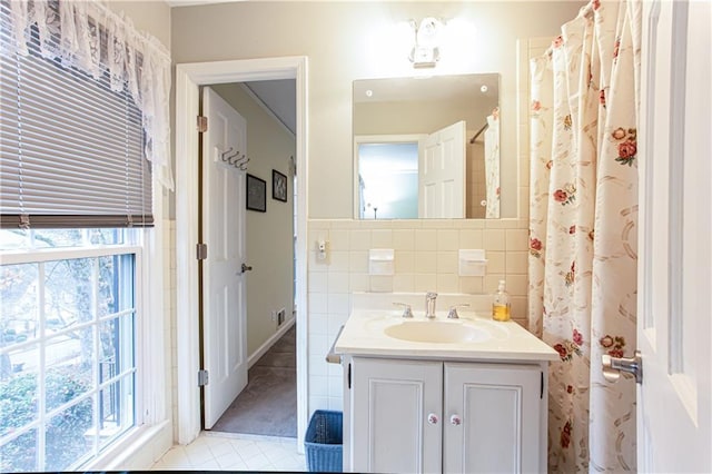 bathroom featuring tile patterned floors, vanity, and tile walls