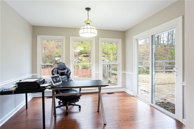 office space with wood-type flooring