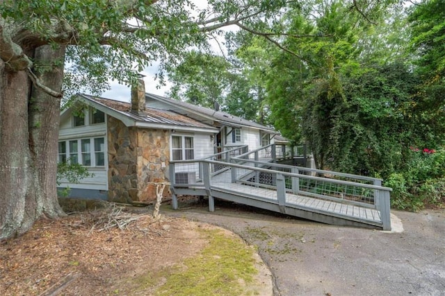 back of property featuring a deck