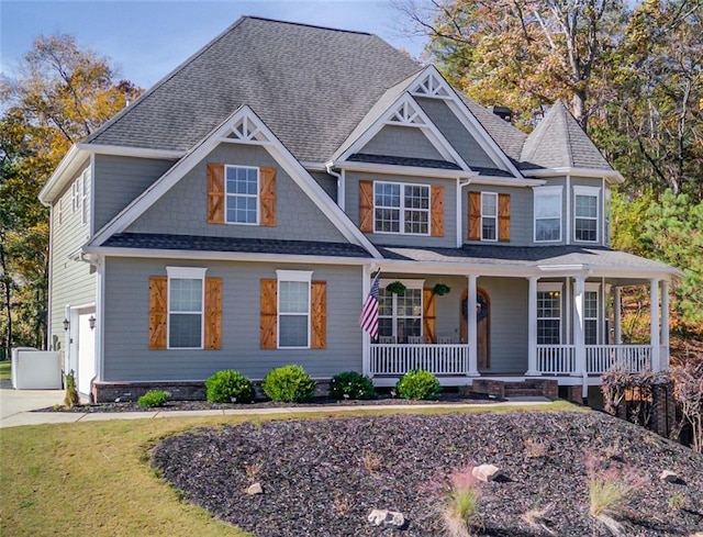 view of front facade with covered porch and a garage