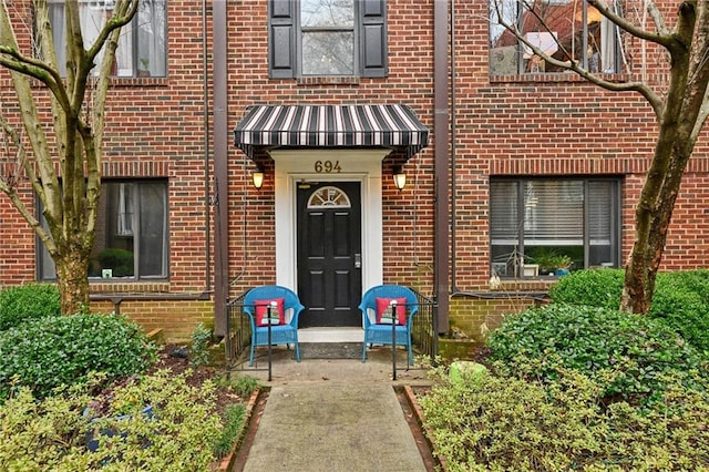 entrance to property with brick siding