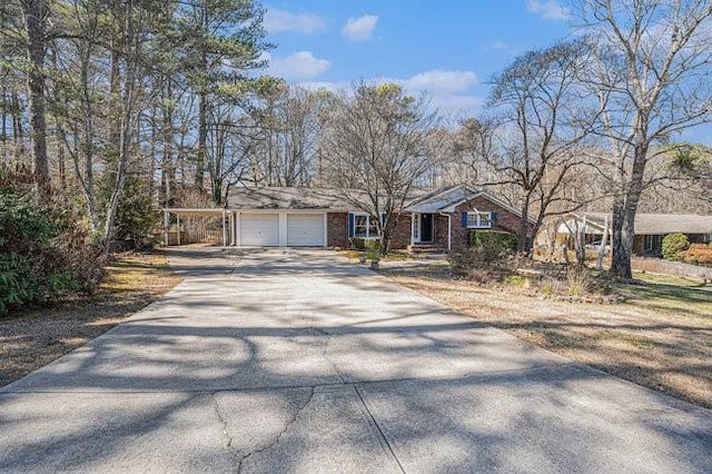 ranch-style home with a garage, concrete driveway, and brick siding