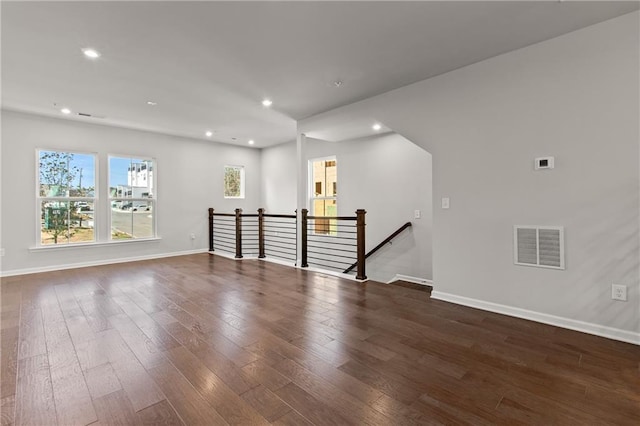 unfurnished room with dark hardwood / wood-style flooring