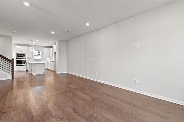 unfurnished living room with dark wood-type flooring