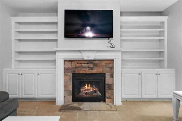 living room featuring light colored carpet and a stone fireplace