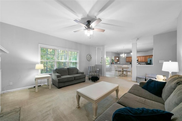 carpeted living room with ceiling fan with notable chandelier