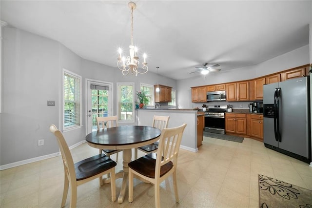 dining room with ceiling fan with notable chandelier