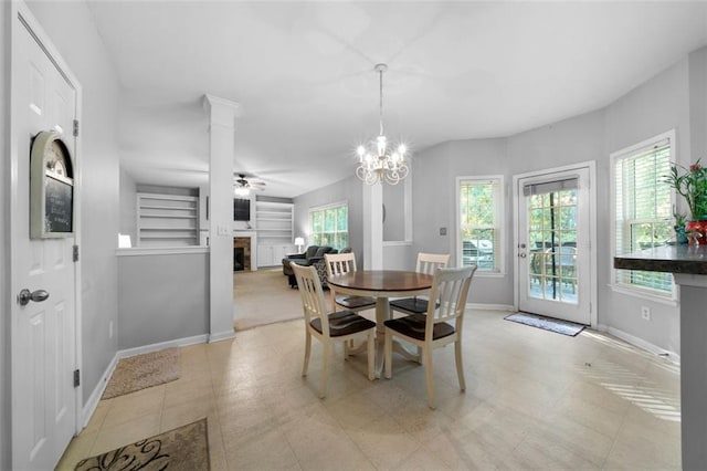 dining space featuring ceiling fan with notable chandelier and light tile patterned floors