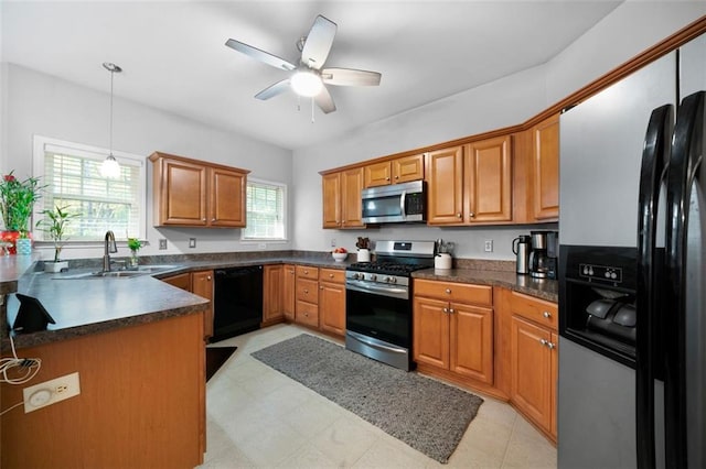 kitchen with pendant lighting, appliances with stainless steel finishes, sink, and plenty of natural light