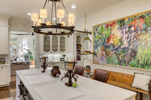 dining space with a notable chandelier, dark wood-type flooring, and ornamental molding