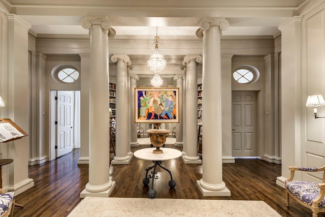 interior space with dark hardwood / wood-style floors and decorative columns