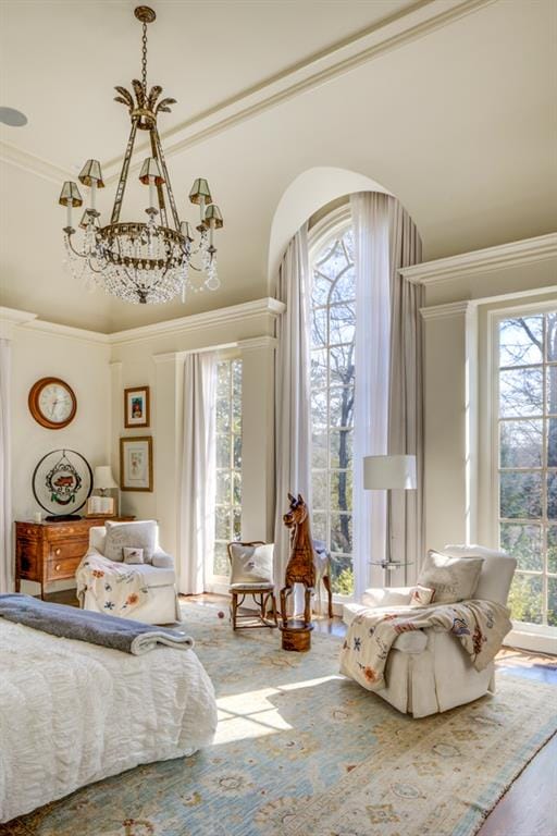 bedroom with a notable chandelier, multiple windows, and hardwood / wood-style flooring