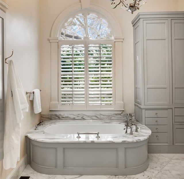 bathroom with plenty of natural light, a tub, and tile patterned floors