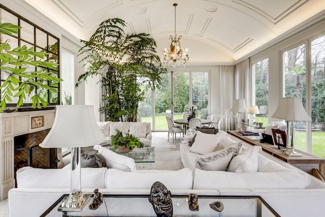 sunroom / solarium featuring a wealth of natural light, lofted ceiling, and a chandelier