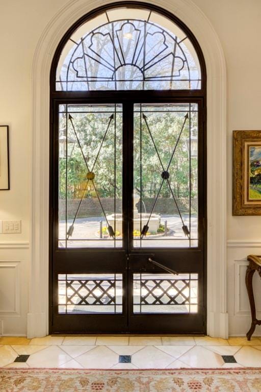 doorway to outside with light tile patterned floors and a wealth of natural light