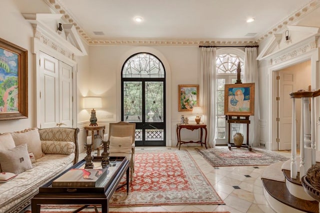 interior space featuring light tile patterned floors, a wealth of natural light, and ornamental molding