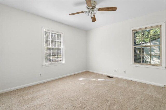 carpeted empty room with ceiling fan