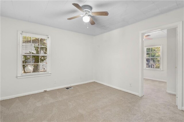 spare room with light carpet and a healthy amount of sunlight