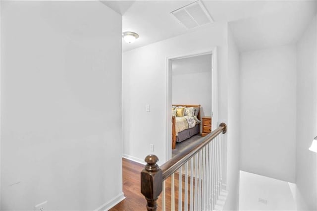 corridor with hardwood / wood-style floors