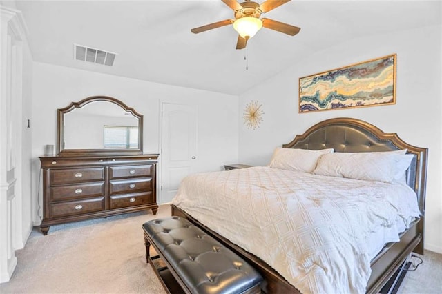 bedroom with vaulted ceiling, ceiling fan, and light colored carpet