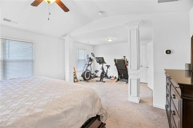 bedroom featuring ceiling fan, light carpet, multiple windows, and ornate columns