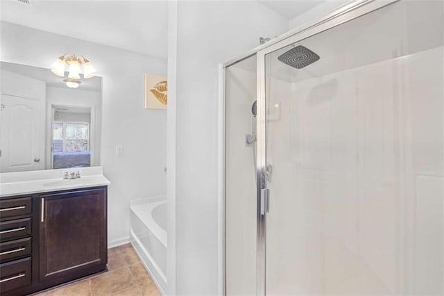 bathroom with vanity, tile patterned flooring, and shower with separate bathtub