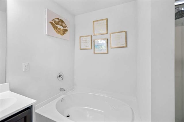 bathroom with vanity and a bath