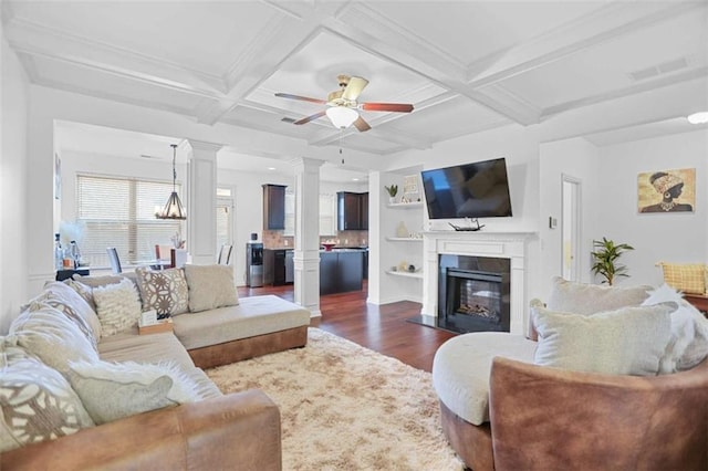 living room featuring dark wood-type flooring, coffered ceiling, built in features, beamed ceiling, and decorative columns